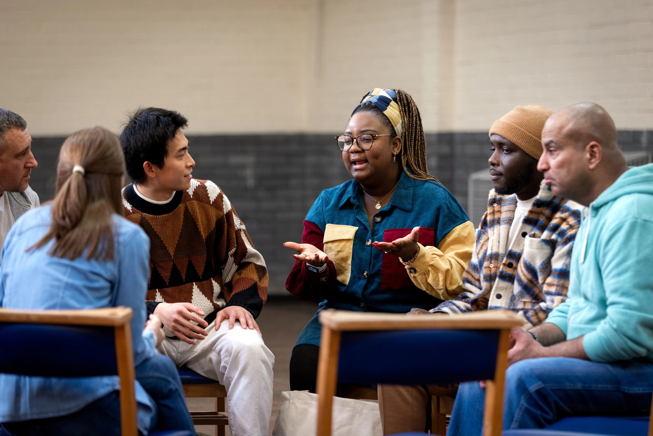 Adults in a circle discussion at a community center