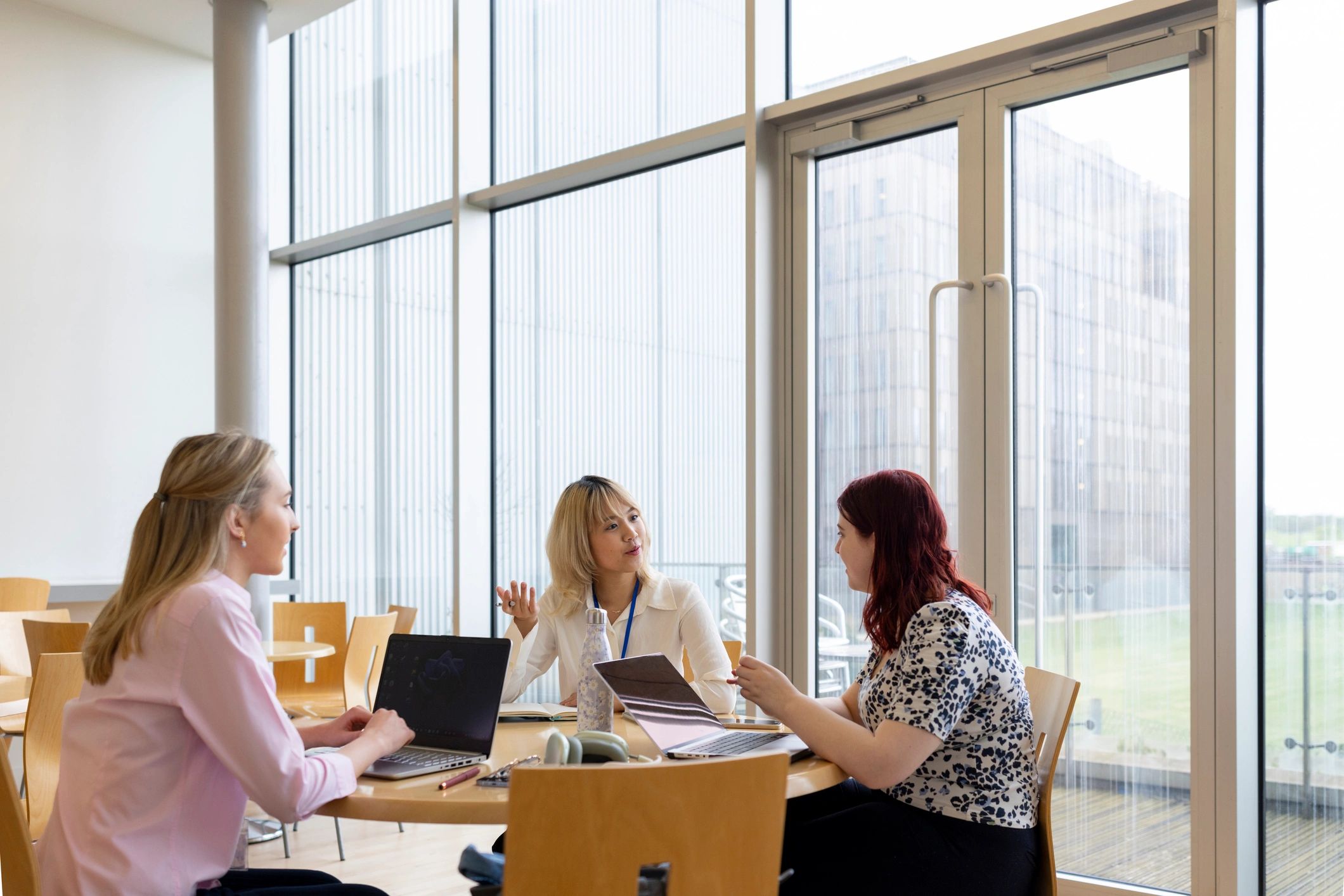 Students collaborating around a table in a bright educational setting